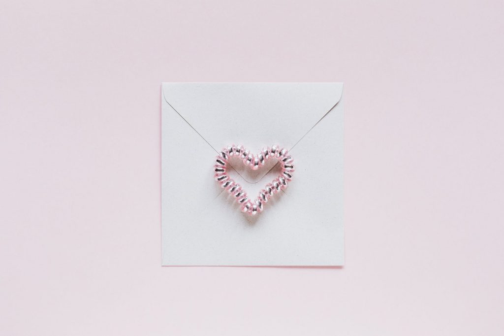 envelope with handmade bead heart on san valentines day