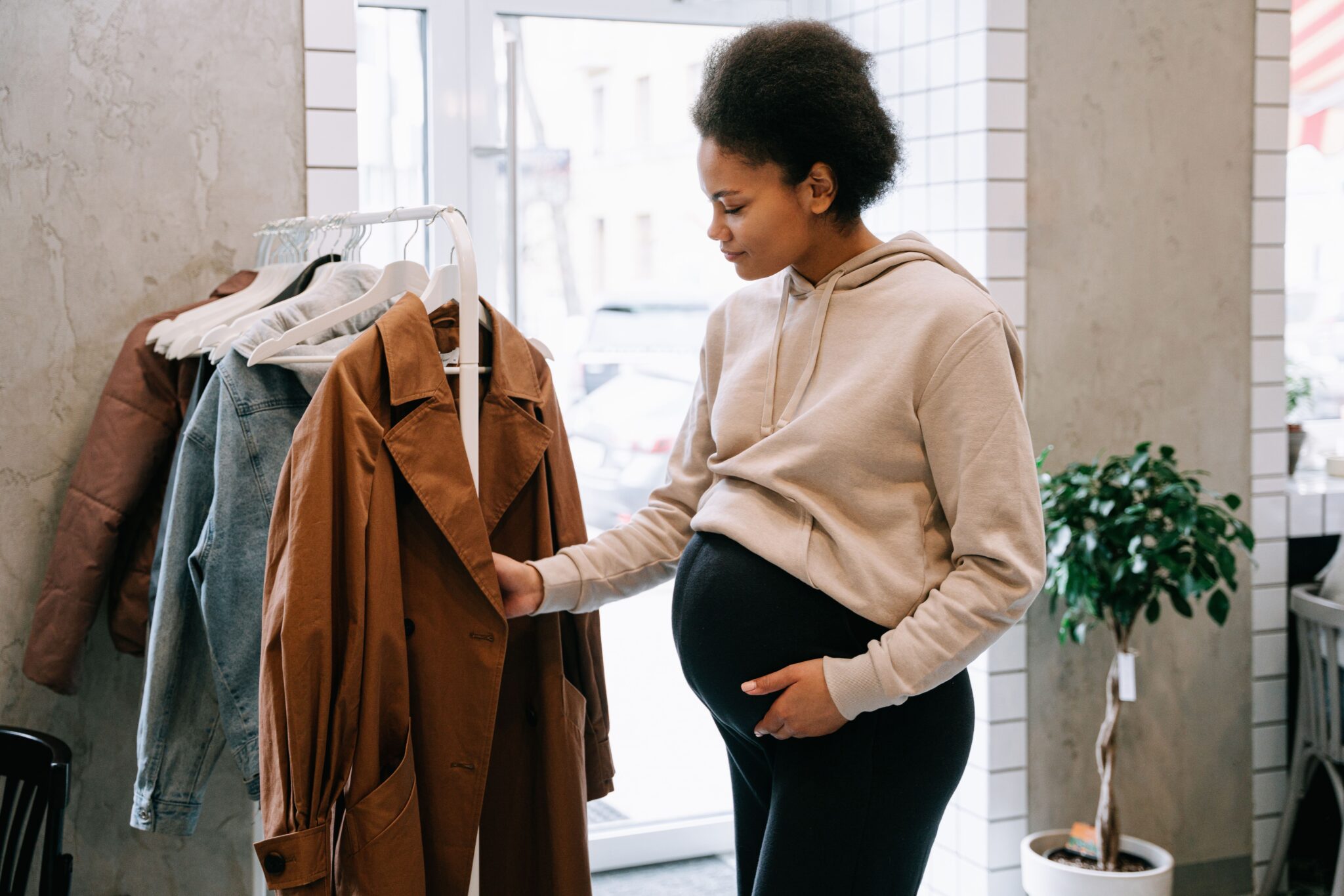 dressing de maternité avec une femme enceinte qui cherche de nouveaux vêtements